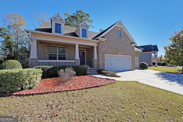 view of front of house with a front yard, a porch, and a garage