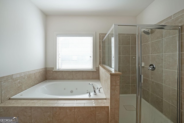 bathroom featuring separate shower and tub