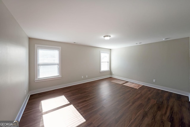 unfurnished room featuring dark wood-type flooring