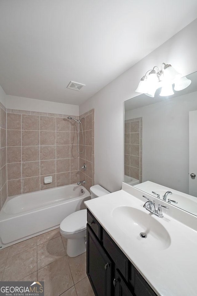 full bathroom featuring vanity, toilet, and tiled shower / bath combo