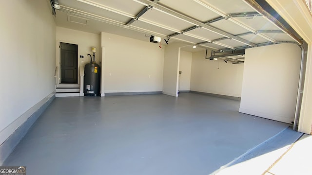 garage with water heater and a garage door opener