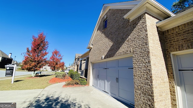 view of home's exterior featuring a lawn and a garage