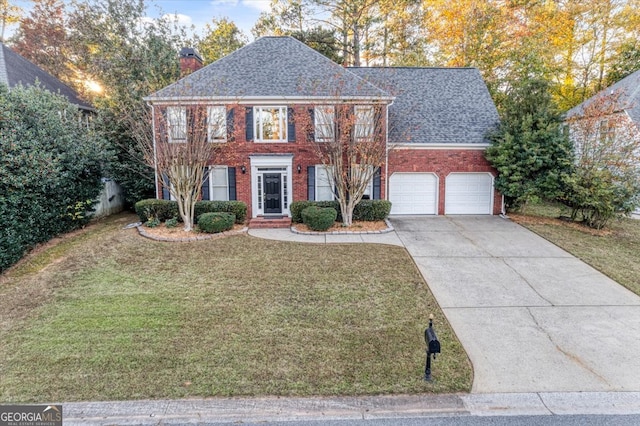 colonial house with a front lawn and a garage