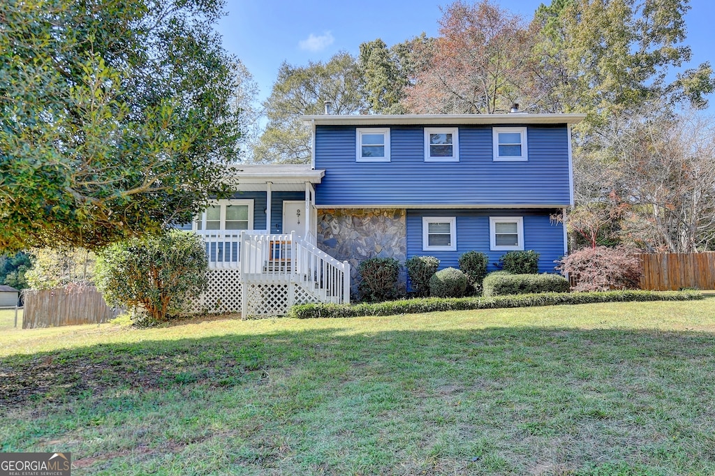 tri-level home with a front yard