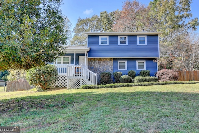 tri-level home with a front yard