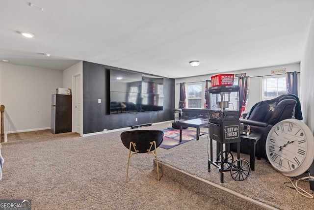 living room featuring carpet and baseboards