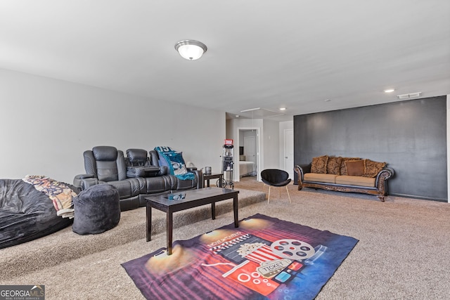 living room featuring visible vents, carpet, attic access, and recessed lighting