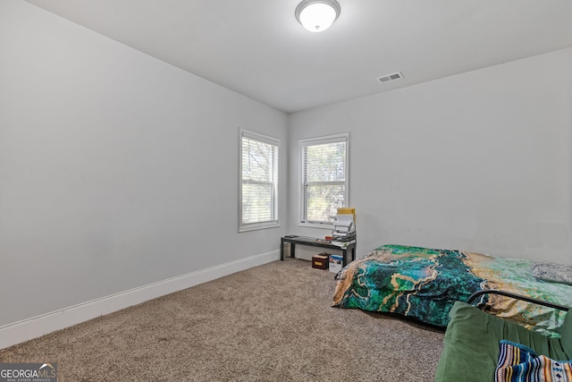 bedroom featuring carpet, visible vents, and baseboards