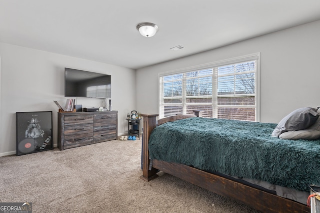 bedroom with baseboards, visible vents, and carpet flooring