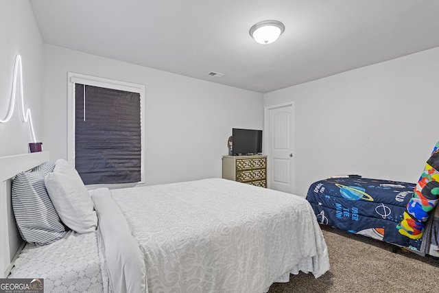 carpeted bedroom featuring visible vents