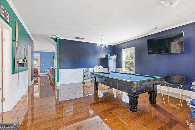 game room featuring a wainscoted wall, visible vents, ornamental molding, and wood finished floors