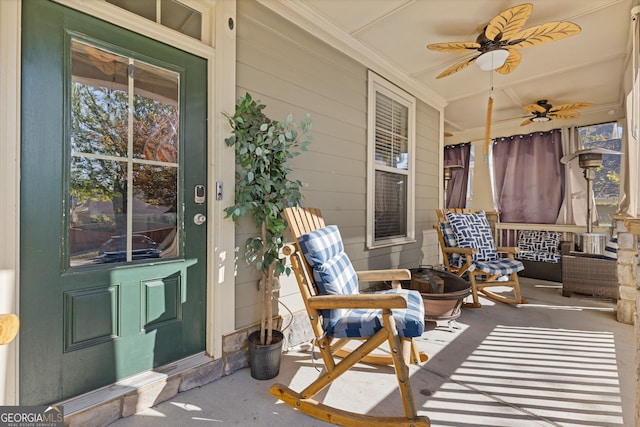 sunroom / solarium featuring ceiling fan