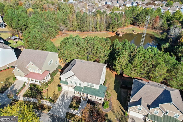 drone / aerial view featuring a water view and a residential view