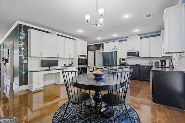 dining space featuring visible vents, dark wood-style flooring, and ornamental molding