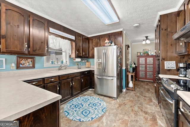 kitchen with sink, stainless steel appliances, a textured ceiling, and ornamental molding