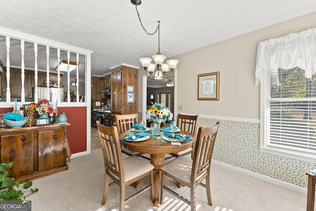 dining area with light colored carpet, a textured ceiling, and a notable chandelier