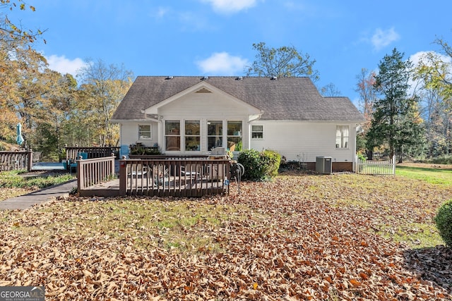 back of house with a wooden deck and central AC