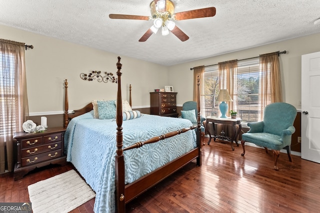 bedroom featuring a textured ceiling, dark hardwood / wood-style floors, and ceiling fan