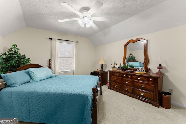 bedroom featuring ceiling fan, light colored carpet, a textured ceiling, and vaulted ceiling