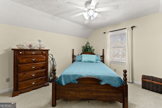 carpeted bedroom featuring a textured ceiling, ceiling fan, and lofted ceiling