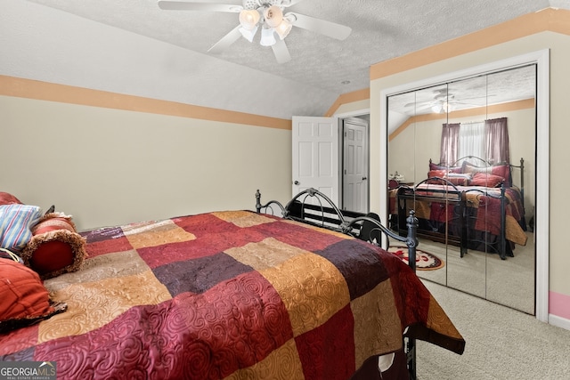 bedroom featuring a textured ceiling, carpet floors, a closet, and ceiling fan