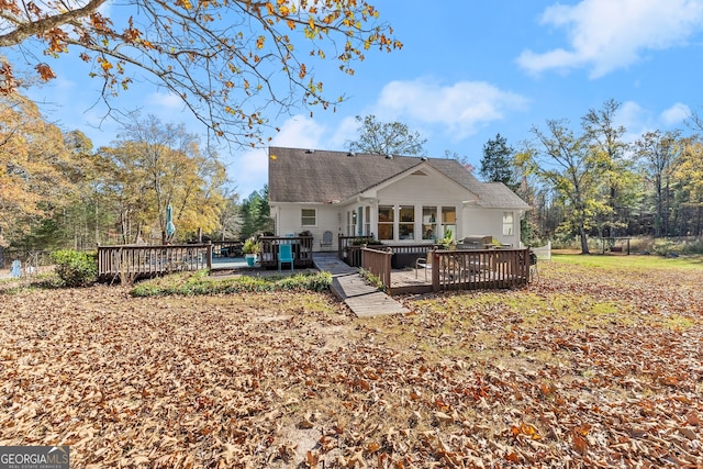 back of house with a deck