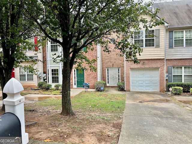 150 Brookview Dr, Riverdale, GA 30274 - townhome / multi-family property featuring brick siding, a garage, and driveway