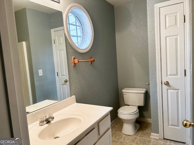 bathroom with tile patterned floors, vanity, and toilet