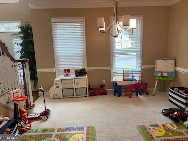 rec room featuring carpet, a chandelier, and plenty of natural light