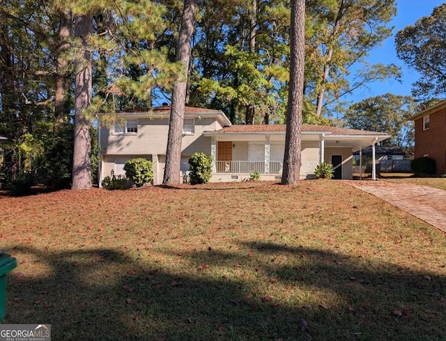 view of front of property with a carport, covered porch, and a front yard