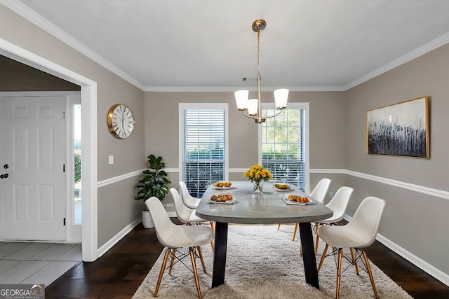 dining room featuring a notable chandelier, dark hardwood / wood-style floors, and ornamental molding