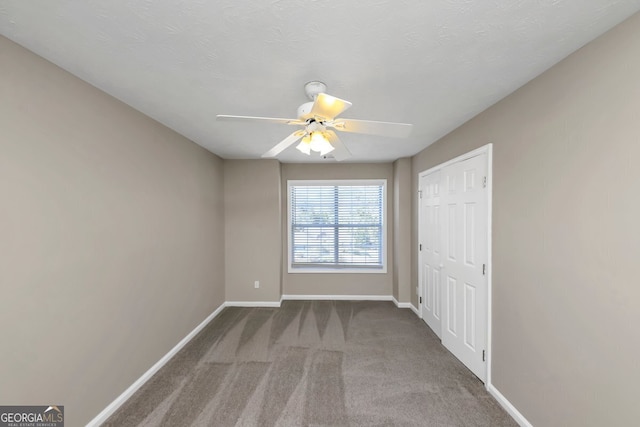 unfurnished room featuring carpet flooring and ceiling fan