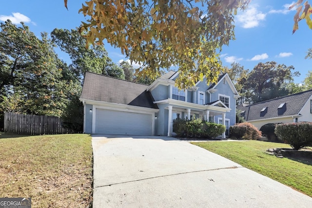 view of property with a garage and a front lawn