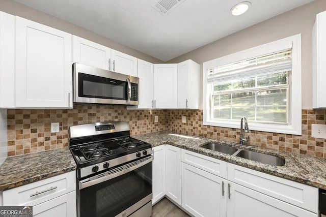 kitchen featuring sink, white cabinetry, and stainless steel appliances