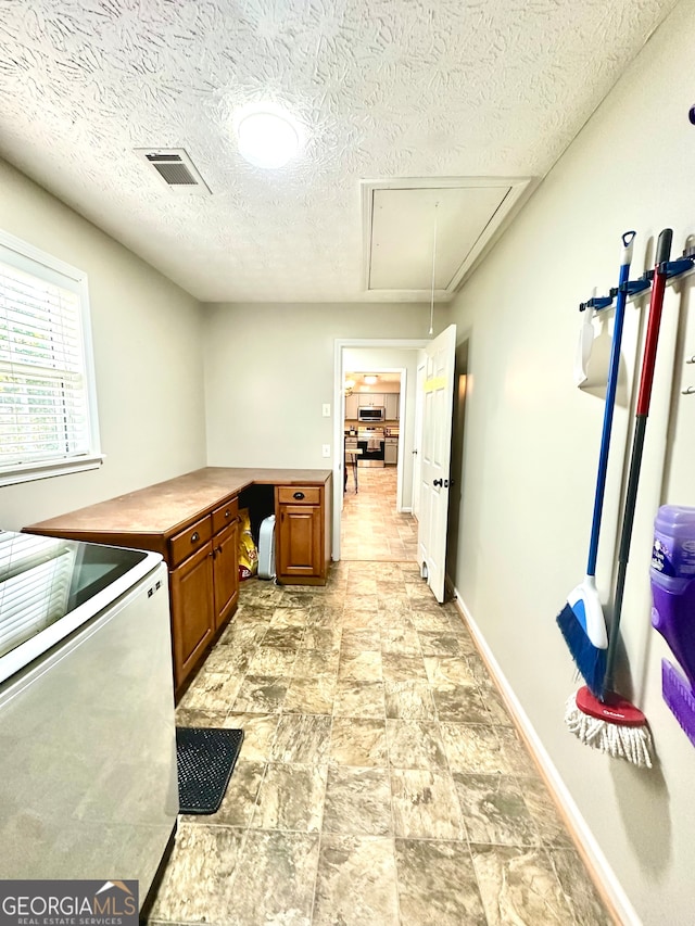 kitchen with stove and a textured ceiling