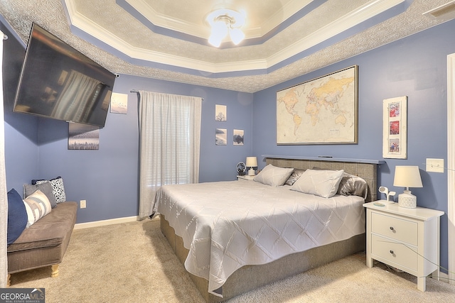 bedroom featuring a tray ceiling, ceiling fan, crown molding, and light carpet