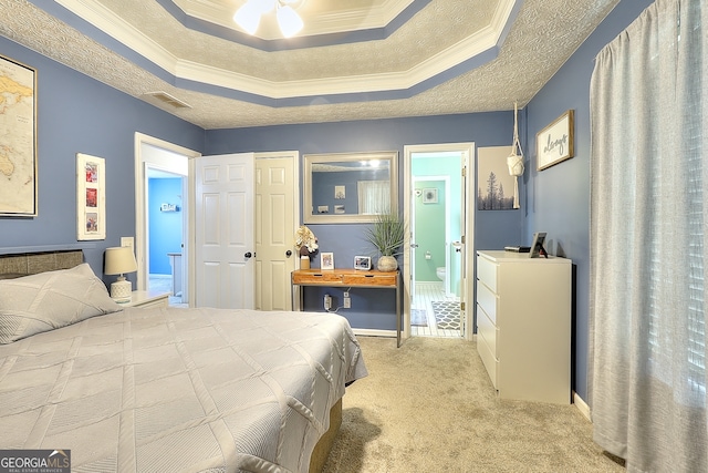 bedroom featuring a tray ceiling, ceiling fan, crown molding, and light colored carpet