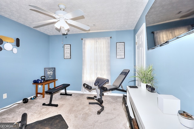 exercise room featuring a textured ceiling, ceiling fan, and light carpet