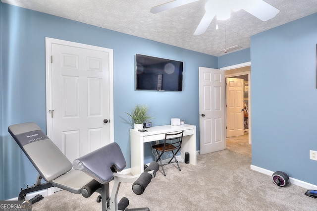 office space featuring ceiling fan, a textured ceiling, and light carpet