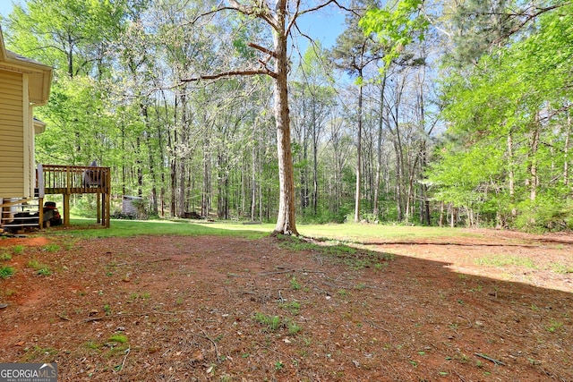 view of yard featuring a wooden deck