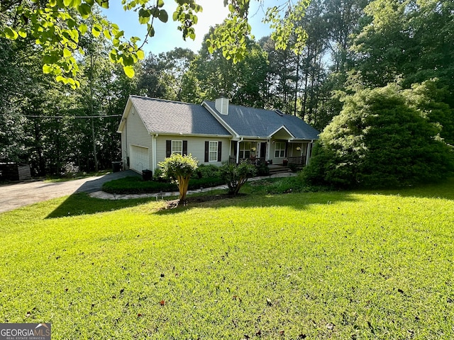 ranch-style home with a garage and a front lawn