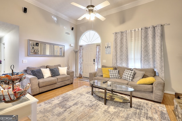 living room featuring light hardwood / wood-style floors, ceiling fan, and ornamental molding