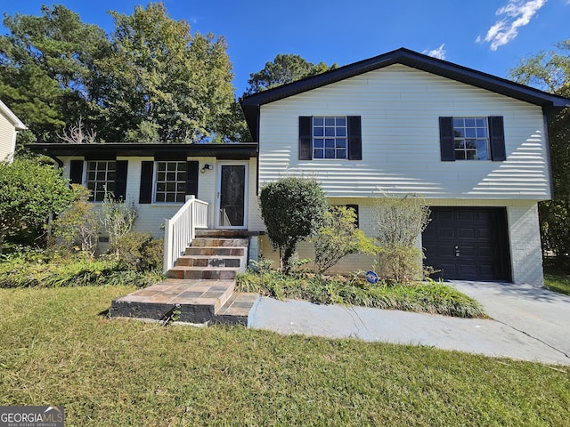 split level home featuring a front yard and a garage