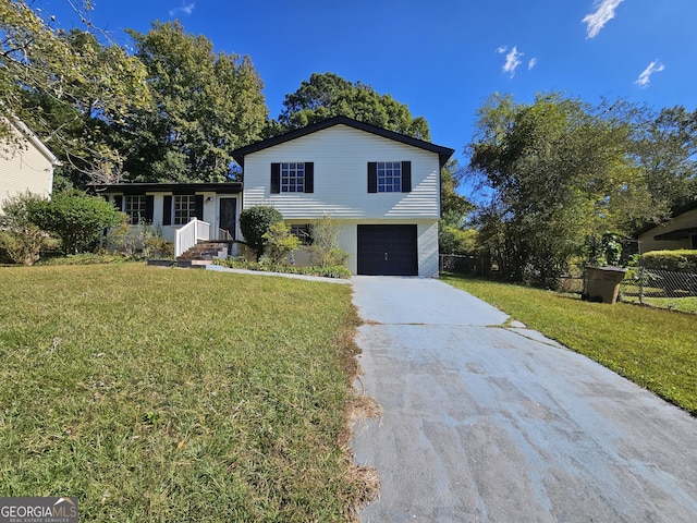 tri-level home featuring a front yard and a garage