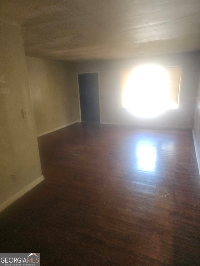 spare room featuring dark hardwood / wood-style floors