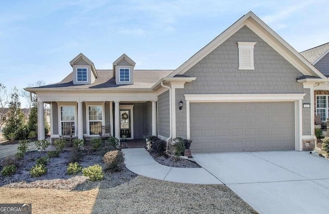 view of front of property with a porch and a garage