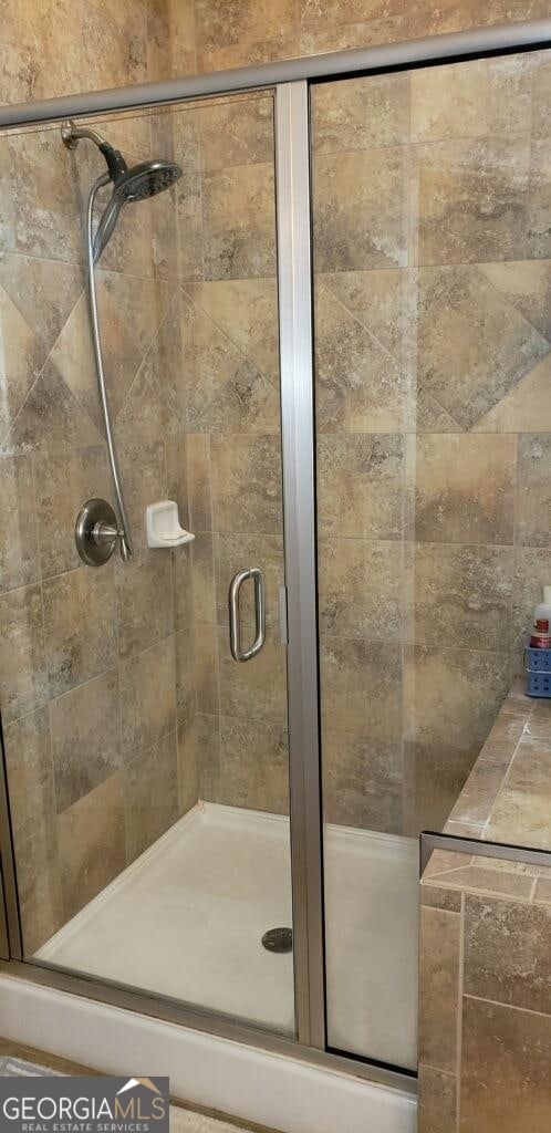 bathroom featuring a shower with door