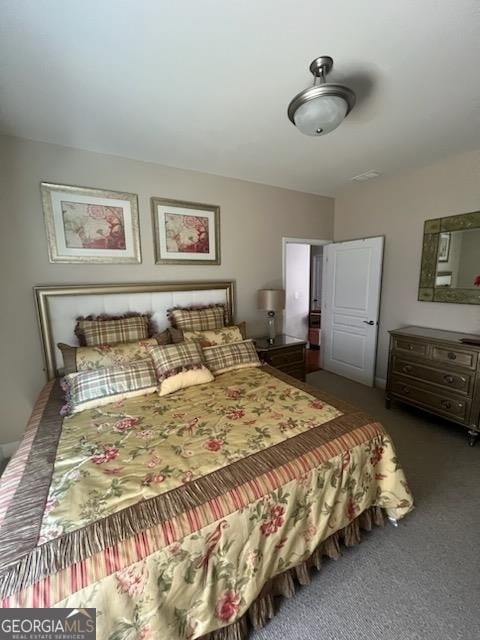 bedroom featuring dark colored carpet