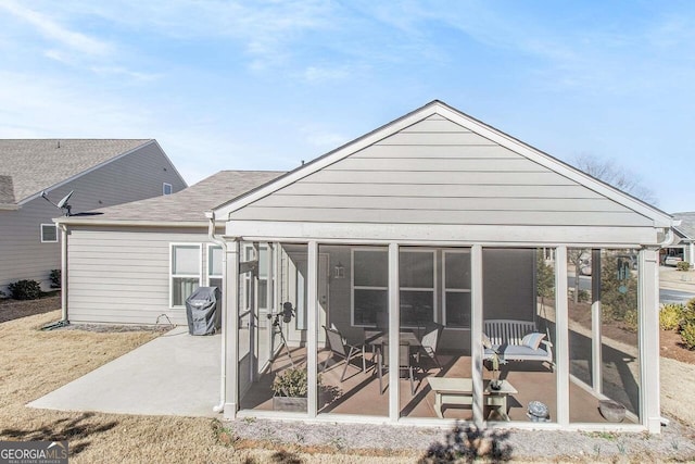 back of house featuring a patio area and a sunroom