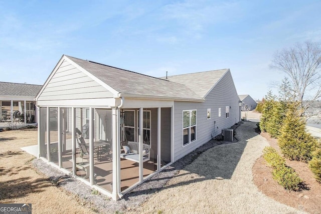 back of house featuring a sunroom and cooling unit